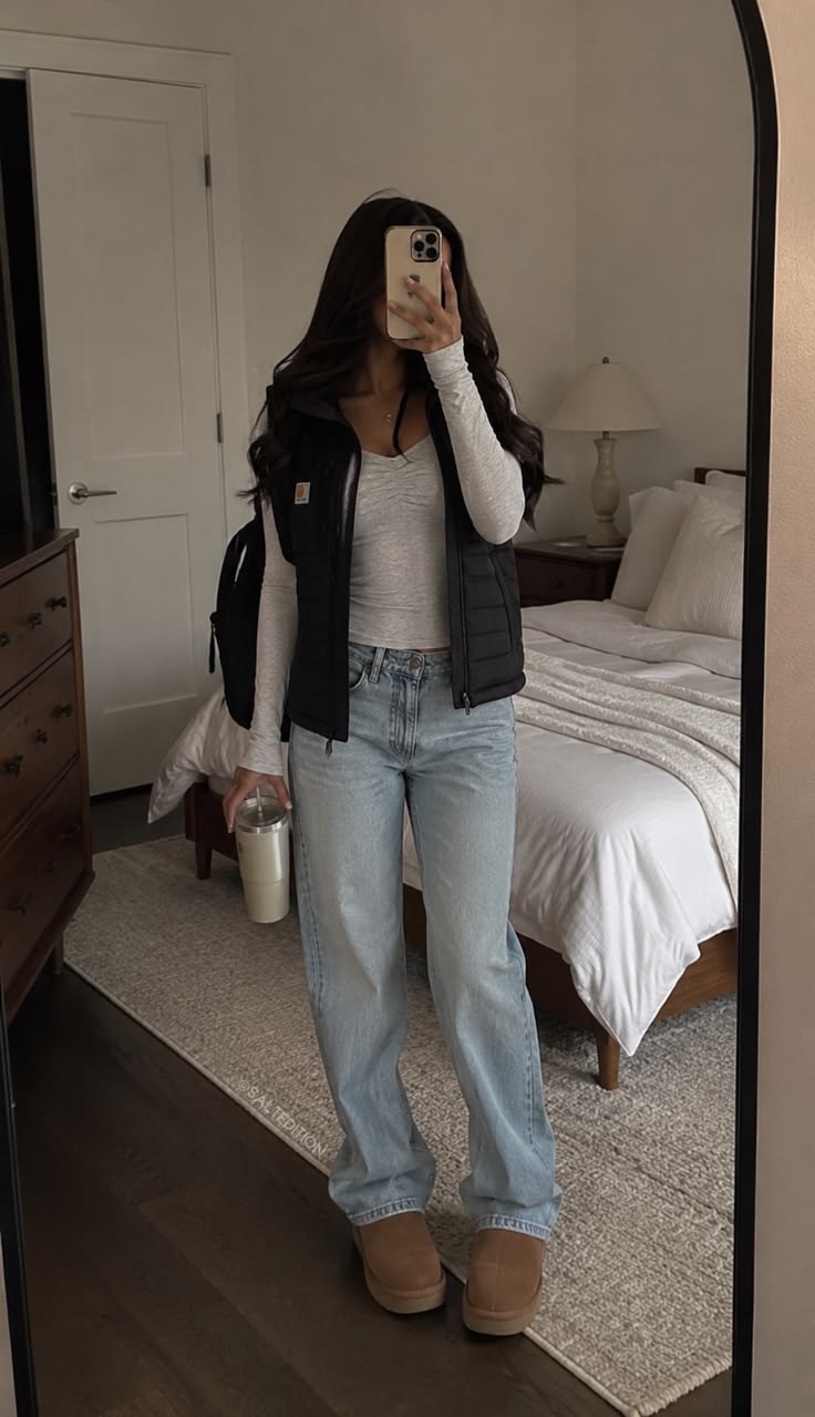 20. Black Quilted Puffer Vest, Heather Gray Ruched Top, and Straight Jeans