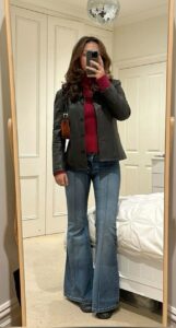 1. Raspberry Turtleneck Under a Black Leather Jacket With Pinstripe Flares
